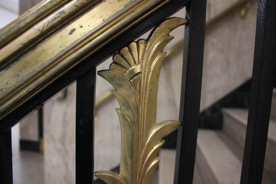 Close up of first floor railing detail, note the details include a scallop at the top and ridges that run the length of the piece.