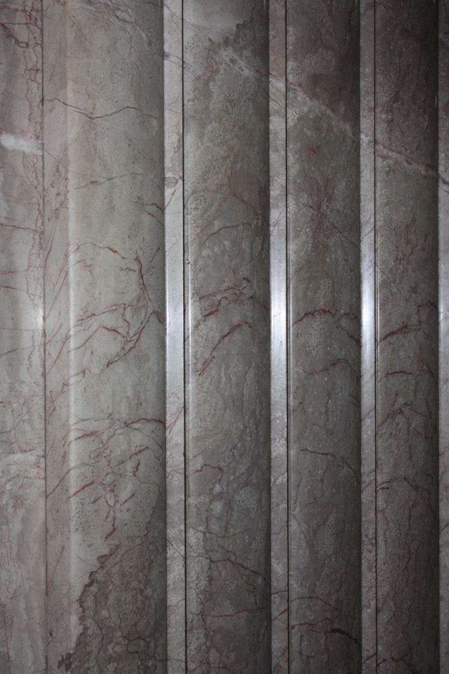 Carved marble panel on first floor lobby. Look closely and you will see it is carved from a single piece of marble and the veins appear to be folded around the curves.