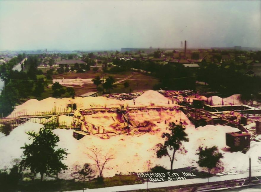 July 31, 1931, the front wall foundations are in place and the ground is being back filled to create the berm accommodating the steps. (Colorized 2022)