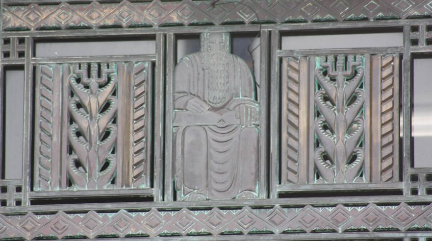 Bronze transom grates over the three main doors to City hall sculpted in the Art Deco style, circa 2022.