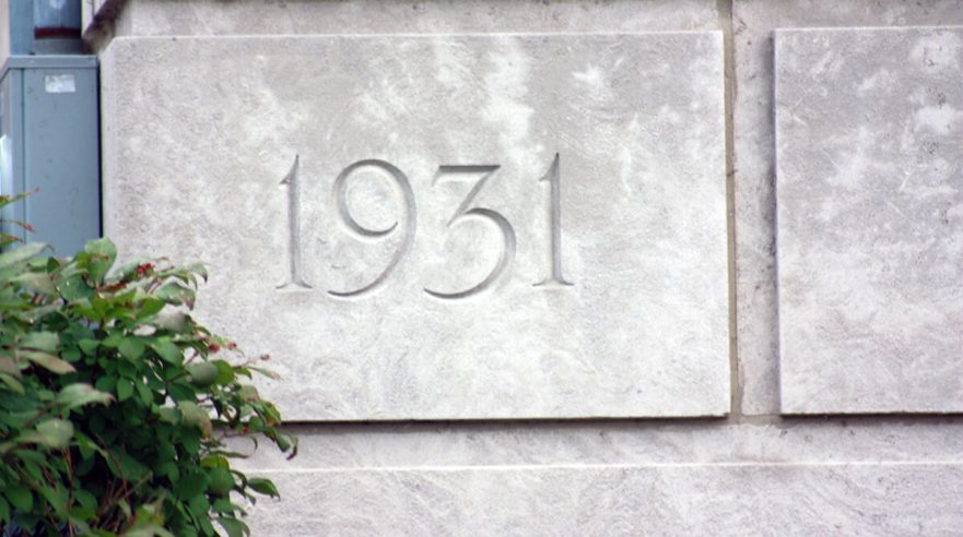 Corner stone dedicating the start date of construction in 1931, circa 2022.