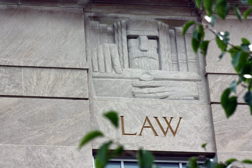 West façade, north corner, note the Art Deco carving of Law, circa 2022.