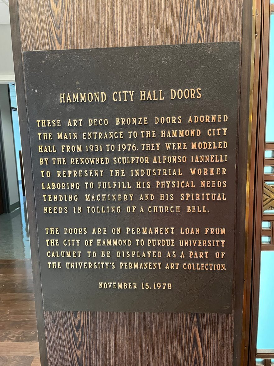 Plaque at Purdue University Northwest Hospitality and Tourisms Management building commemorating the installation of the original Iannelli bronze doors.