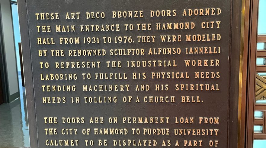 Plaque at Purdue University Northwest Hospitality and Tourisms Management building commemorating the installation of the original Iannelli bronze doors.